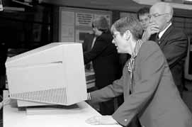 At the Lederman, Center Liz Quigg shows Congressman Ehlers and Staffer Michael Lach the Detector Detail exhibit