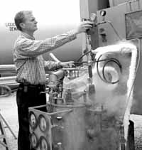 Jay Theilacker, head of the Cryogenic Department, inspects equipment of the cooling system.