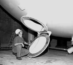 Rex Tayloe, Assistant Professor at Indiana University, inspects the MiniBooNE oil tank.