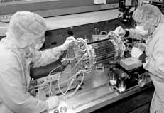 Andrew Foland (left) and Bert Gonzalez work on SVXII silicon wafers.