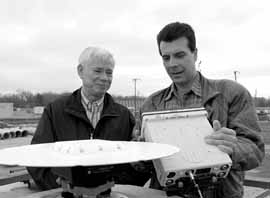 Wesley Smart and Vigil Bocean work with a GPS receiver while testing alignment of NuMI Beam Line