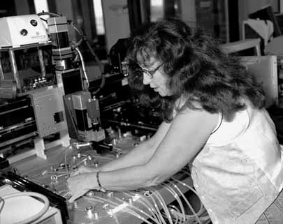 Irina Sirotenko (above) is working with Lenny Spiegel and Bill Kahl to install the first of two robots that will help assemble the more than 5000 silicon modules for the CMS detector