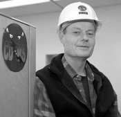 CDMS Project Manager Roger Dixon displays the experiment logo celebrating the constant presence of bats in the Soudan Mine