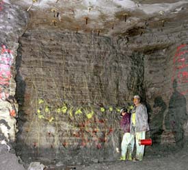 Miners, here wiring explosives inserted into the rock, set off more than 400 blasts to create three shafts and two huge underground halls.