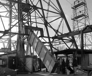 Crate of scintillating plastic being unloaded from a truck and placed on the elevator in the mineshaft.