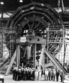 Representatives of CMS and DWE display the first wheel.